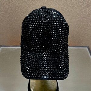 Black studded snap back ball cap.